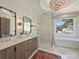 Spa-like bathroom with double sinks, a glass-enclosed shower, and a soaking tub at 2004 Lombardy Cir, Charlotte, NC 28203