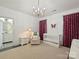 Bright Bedroom features a baby crib, a butterfly painting, and dark pink curtains at 2004 Lombardy Cir, Charlotte, NC 28203