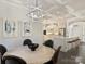 Elegant dining area with modern lighting, art, and an open view to the kitchen and breakfast bar at 2004 Lombardy Cir, Charlotte, NC 28203