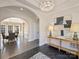 Spacious foyer with decorative lighting, black floors, console table and view into adjacent rooms at 2004 Lombardy Cir, Charlotte, NC 28203