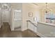 Upstairs hallway with hardwood floors, designer lighting, and bathroom at 2004 Lombardy Cir, Charlotte, NC 28203