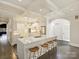 Spacious kitchen with a large island, white cabinets, coffered ceilings and wooden stools at 2004 Lombardy Cir, Charlotte, NC 28203
