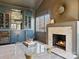 Cozy living room with built-in wet bar, marble fireplace, decor and lots of natural light at 2004 Lombardy Cir, Charlotte, NC 28203