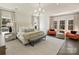Serene main bedroom with a seating area, plush carpet, and large windows at 2004 Lombardy Cir, Charlotte, NC 28203