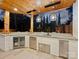 This outdoor kitchen features stainless steel appliances and hanging lights for upscale outdoor entertaining at 2004 Lombardy Cir, Charlotte, NC 28203