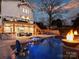A backyard with a pool, lounge area, bar, and exterior access to the second story of the house at 2004 Lombardy Cir, Charlotte, NC 28203