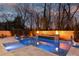 A luxurious pool area is enhanced by a built-in spa, water feature, fire bowls and a basketball hoop at 2004 Lombardy Cir, Charlotte, NC 28203