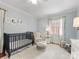 Cozy Bedroom featuring a dark crib, comfortable chair, and soft rug, creating a welcoming atmosphere at 2009 Charlotte Dr, Charlotte, NC 28203