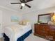 Comfortable bedroom features a full-sized bed, ceiling fan, dresser, and closet at 2009 Charlotte Dr, Charlotte, NC 28203