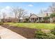 A row of charming homes with well-manicured lawns line a tree-filled neighborhood street at 2009 Charlotte Dr, Charlotte, NC 28203