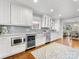 Bright kitchen features white cabinets, stainless steel appliances, and a cozy breakfast nook at 2009 Charlotte Dr, Charlotte, NC 28203