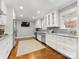 Bright kitchen features white cabinetry, stainless steel appliances, and a beautiful Persian rug at 2009 Charlotte Dr, Charlotte, NC 28203