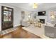 Bright living room with fireplace, large windows, hardwood floors, and neutral decor at 2009 Charlotte Dr, Charlotte, NC 28203