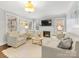 Comfortable living room with a fireplace, hardwood floors, and plenty of natural light at 2009 Charlotte Dr, Charlotte, NC 28203