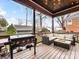 Inviting covered porch with comfortable seating and a grill, perfect for outdoor entertaining at 2009 Charlotte Dr, Charlotte, NC 28203