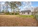 View of house from grassy backyard, features trees and partly cloudy sky at 202 Hovis Rd, Stanley, NC 28164