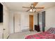 Bedroom features a red plaid bedspread, ceiling fan, and neutral walls, providing a cozy atmosphere at 202 Hovis Rd, Stanley, NC 28164