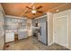 Functional kitchen features gray cabinets, tile backsplash, and an open view into the living area at 202 Hovis Rd, Stanley, NC 28164