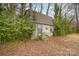 Exterior view of a shed with a metal door frame surrounded by trees and foliage at 202 Hovis Rd, Stanley, NC 28164