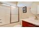 A bathroom with a white shower-tub combo with a sliding door and a single sink vanity at 2129 Jack Wilson Rd, Shelby, NC 28150