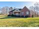 Well-maintained brick home with manicured lawn, garden, and mature trees at 2129 Jack Wilson Rd, Shelby, NC 28150