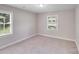Comfortable bedroom featuring neutral colors, soft carpet, and abundant natural light from large windows at 2328 Edison St, Charlotte, NC 28206