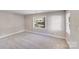Sunlit bedroom with fresh paint, neutral carpet, and large windows offering pleasant outdoor views at 2328 Edison St, Charlotte, NC 28206