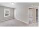 Cozy bedroom with neutral tones, soft carpeting, a sunny window, and easy access to other rooms at 2328 Edison St, Charlotte, NC 28206