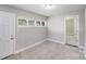 Bright bedroom with large window, neutral carpet, and interior door at 2328 Edison St, Charlotte, NC 28206