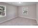 Neutrally decorated bedroom with natural light from two windows at 2328 Edison St, Charlotte, NC 28206
