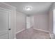 Bedroom featuring neutral carpet, natural light, and interior door at 2328 Edison St, Charlotte, NC 28206