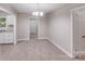 Dining room with neutral walls, plush carpet, and chandelier lighting fixture at 2328 Edison St, Charlotte, NC 28206