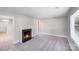Bright living room with a cozy fireplace, neutral paint, plush carpet, and ample natural light at 2328 Edison St, Charlotte, NC 28206
