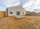 View of fenced backyard with sliding glass door and small patio at 239 Damask Dr, Lancaster, SC 29720