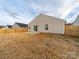 View of fenced backyard with sliding glass door and small patio at 239 Damask Dr, Lancaster, SC 29720