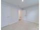 Clean, bright bedroom with a door and light-colored carpet, offering a blank canvas at 239 Damask Dr, Lancaster, SC 29720