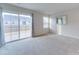 Well-lit bedroom features a large window, sliding glass doors, and a neutral color palette at 239 Damask Dr, Lancaster, SC 29720