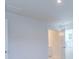 Bright hallway leading to a bathroom with neutral walls, and a double door for added privacy at 239 Damask Dr, Lancaster, SC 29720