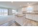 Open-concept kitchen featuring granite counters, white cabinetry, and an adjacent living area at 239 Damask Dr, Lancaster, SC 29720