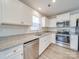 Well-lit kitchen with stainless steel appliances, granite countertops, and white cabinets at 239 Damask Dr, Lancaster, SC 29720