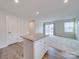 Open concept view of kitchen with island bar and a living room with sliding glass door at 239 Damask Dr, Lancaster, SC 29720