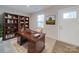 Bright home office with built in bookshelves, large desk, and a neutral color scheme at 239 Damask Dr, Lancaster, SC 29720
