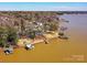 Aerial view of waterfront homes on Lake Wylie with private docks and mature trees at 3030 Point Clear Dr, Tega Cay, SC 29708