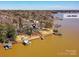 Aerial view of waterfront home on Lake Wylie with private dock and surrounding trees at 3030 Point Clear Dr, Tega Cay, SC 29708