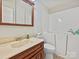 Bathroom features a wood vanity, matching mirror, walk in bath tub, tile floor, and neutral paint at 3030 Point Clear Dr, Tega Cay, SC 29708