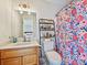 Cozy bathroom with decorative floral shower curtain, vintage vanity and shelf at 3030 Point Clear Dr, Tega Cay, SC 29708