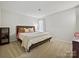 Cozy bedroom featuring carpet, neutral paint, decorative pillows, and a queen size bed at 3030 Point Clear Dr, Tega Cay, SC 29708