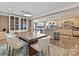 Open dining space showcasing a large wooden table with comfortable seating with views into the kitchen and living areas at 3030 Point Clear Dr, Tega Cay, SC 29708