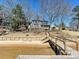 Lakefront home featuring private beach access, dock, and stairs leading up to the house at 3030 Point Clear Dr, Tega Cay, SC 29708