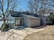 Well-maintained single-story house with a neutral exterior, mature trees, and a concrete driveway at 3030 Point Clear Dr, Tega Cay, SC 29708